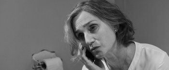 Movie still from “The Party” (2017), directed by Sally Potter – A person talking on a cell phone; Close Up shot, Over the shoulder angle