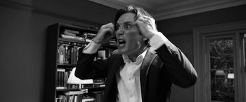 Movie still from “The Party” (2017), directed by Sally Potter – A black and white photo of a man in a suit; Close Up shot, Low angle