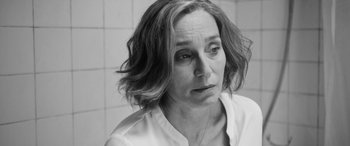 Movie still from “The Party” (2017), directed by Sally Potter – Black and white photograph of a woman looking sad; Close Up shot, Over the shoulder angle
