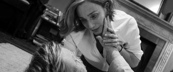 Movie still from “The Party” (2017), directed by Sally Potter – A woman in white shirt and tie holding her hand to her face; Close Up shot, Over the shoulder angle