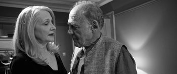 Movie still from “The Party” (2017), directed by Sally Potter – An older man wearing a suit and a tie; Close Up shot, Over the shoulder angle