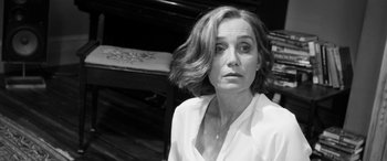 Movie still from “The Party” (2017), directed by Sally Potter – Black and white photograph of a woman in front of a piano; Close Up shot, Over the shoulder angle