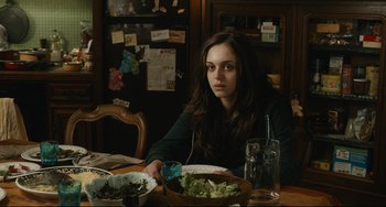 Movie still from “The Past” (2013), directed by Asghar Farhadi – A woman sitting at a table with a bowl of salad; Medium shot, Over the shoulder angle
