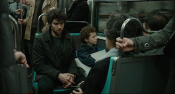 Movie still from “The Past” (2013), directed by Asghar Farhadi – A group of people sitting on top of a train; Medium shot, Over the shoulder angle