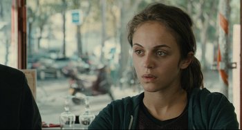 Movie still from “The Past” (2013), directed by Asghar Farhadi – A woman sitting at a table in front of a motorcycle; Close Up shot, Over the shoulder angle