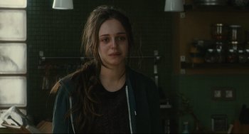 Movie still from “The Past” (2013), directed by Asghar Farhadi – A young woman with long brown hair is looking at the camera; Close Up shot, Over the shoulder angle