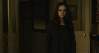 Movie still from “The Past” (2013), directed by Asghar Farhadi – A woman standing in a dark room in front of a mirror; Medium shot, Over the shoulder angle