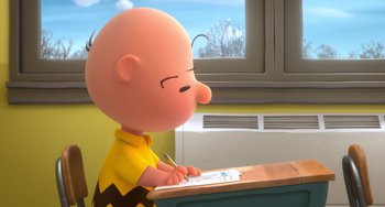 Movie still from “The Peanuts Movie” (2015), directed by Steve Martino – Charlie brown sitting at a desk writing on a piece of paper; Medium shot, Over the shoulder angle