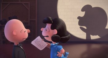 Movie still from “The Peanuts Movie” (2015), directed by Steve Martino – A woman holding a piece of paper while standing next to another woman; Medium shot, Over the shoulder angle
