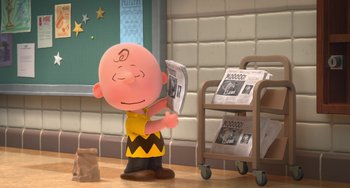 Movie still from “The Peanuts Movie” (2015), directed by Steve Martino – A charlie brown figurine is holding a newspaper; Wide shot, High angle