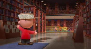 Movie still from “The Peanuts Movie” (2015), directed by Steve Martino – A charlie brown statue in a room full of bookshelves; Extreme Wide shot, High angle
