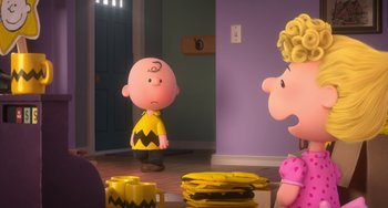 Movie still from “The Peanuts Movie” (2015), directed by Steve Martino – A charlie brown character standing in front of a bunch of bananas; Medium shot, Over the shoulder angle