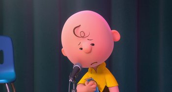 Movie still from “The Peanuts Movie” (2015), directed by Steve Martino – A cartoon of a bald man with a microphone; Medium shot, Low angle