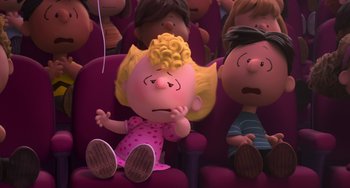 Movie still from “The Peanuts Movie” (2015), directed by Steve Martino – A little girl sitting in a movie theater with other people; Medium shot, High angle