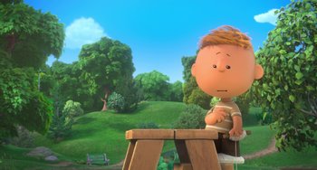 Movie still from “The Peanuts Movie” (2015), directed by Steve Martino – A charlie brown character sitting at a bench; Medium shot, Low angle