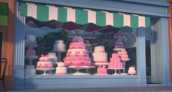 Movie still from “The Peanuts Movie” (2015), directed by Steve Martino – A window display of a variety of cakes in pink and white; Wide shot, Over the shoulder angle