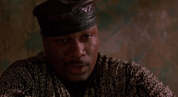Movie still from “The People Under the Stairs” (1991), directed by Wes Craven – A person wearing a hat; Close Up shot, Low angle