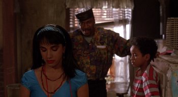 Movie still from “The People Under the Stairs” (1991), directed by Wes Craven – A man and a woman standing next to a boy; Medium shot, Over the shoulder angle