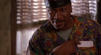 Movie still from “The People Under the Stairs” (1991), directed by Wes Craven – A person wearing a hat; Close Up shot, Low angle