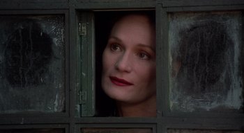 Movie still from “The People Under the Stairs” (1991), directed by Wes Craven – A person looking out of a window; Close Up shot, Low angle