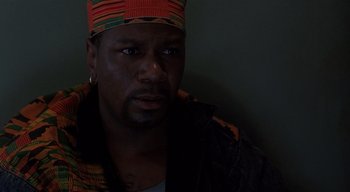 Movie still from “The People Under the Stairs” (1991), directed by Wes Craven – A person wearing a hat; Close Up shot, Low angle