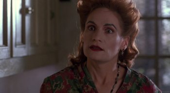 Movie still from “The People Under the Stairs” (1991), directed by Wes Craven – A person wearing a floral shirt; Close Up shot, Over the shoulder angle