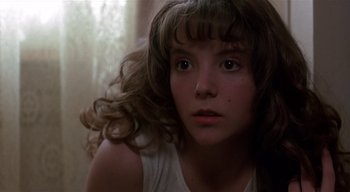 Movie still from “The People Under the Stairs” (1991), directed by Wes Craven – A young girl is looking into the camera; Close Up shot, Low angle