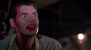 Movie still from “The People Under the Stairs” (1991), directed by Wes Craven – A person with blood all over his face; Close Up shot, Low angle