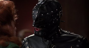 Movie still from “The People Under the Stairs” (1991), directed by Wes Craven – A man in a leather mask and leather jacket; Close Up shot, Low angle