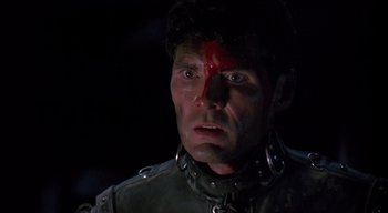 Movie still from “The People Under the Stairs” (1991), directed by Wes Craven – A person wearing a helmet with blood on his face; Close Up shot, Low angle