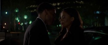 Movie still from “The Perfect Guy” (2015), directed by David M. Rosenthal – A man and a woman standing next to each other in front of lights; Close Up shot, Over the shoulder angle