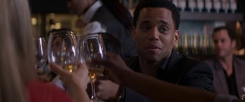Movie still from “The Perfect Guy” (2015), directed by David M. Rosenthal – A group of people sitting at a table holding wine glasses; Close Up shot, Over the shoulder angle