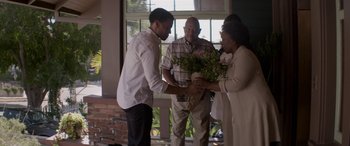 Movie still from “The Perfect Guy” (2015), directed by David M. Rosenthal – A man and two women holding a bouquet of flowers; Medium shot, Over the shoulder angle
