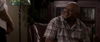 Movie still from “The Perfect Guy” (2015), directed by David M. Rosenthal – A man sitting on a leather chair in a living room; Close Up shot, Over the shoulder angle