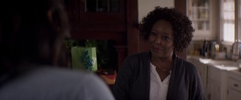 Movie still from “The Perfect Guy” (2015), directed by David M. Rosenthal – A woman sitting at a table with a gift bag in front of her; Close Up shot, Over the shoulder angle