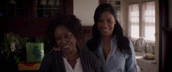 Movie still from “The Perfect Guy” (2015), directed by David M. Rosenthal – Two women smile for the camera while posing for a picture; Close Up shot, High angle