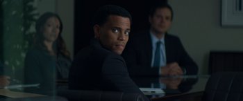 Movie still from “The Perfect Guy” (2015), directed by David M. Rosenthal – A man in a black suit sitting in front of another man in a black suit; Close Up shot, Over the shoulder angle
