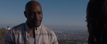 Movie still from “The Perfect Guy” (2015), directed by David M. Rosenthal – A man standing on top of a hill in front of a city; Close Up shot, Over the shoulder angle