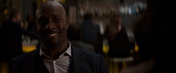 Movie still from “The Perfect Guy” (2015), directed by David M. Rosenthal – A person wearing a suit and smiling; Close Up shot, Over the shoulder angle