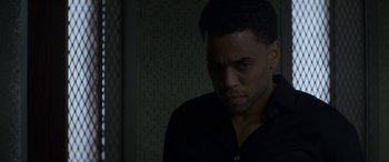 Movie still from “The Perfect Guy” (2015), directed by David M. Rosenthal – A man in a black shirt is standing in a room; Close Up shot, Over the shoulder angle