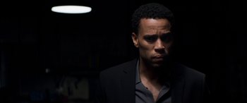 Movie still from “The Perfect Guy” (2015), directed by David M. Rosenthal – A man wearing a suit and tie in a dark room; Close Up shot, Over the shoulder angle