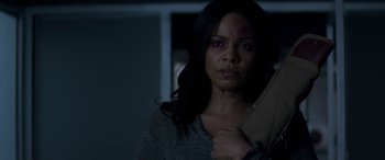 Movie still from “The Perfect Guy” (2015), directed by David M. Rosenthal – A woman holding a knife in a dark room; Close Up shot, Over the shoulder angle