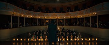 Movie still from “The Personal History of David Copperfield” (2019), directed by Armando Iannucci – A man in a black coat is standing in front of a crowd; Extreme Wide shot, High angle