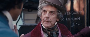 Movie still from “The Personal History of David Copperfield” (2019), directed by Armando Iannucci – A person wearing a hat; Close Up shot, Over the shoulder angle