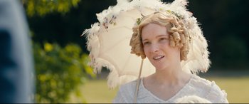Movie still from “The Personal History of David Copperfield” (2019), directed by Armando Iannucci – A young woman with blonde ringlets holding an umbrella; Close Up shot, High angle