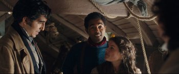 Movie still from “The Personal History of David Copperfield” (2019), directed by Armando Iannucci – A man and a woman standing next to each other; Medium shot, Over the shoulder angle