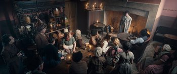 Movie still from “The Personal History of David Copperfield” (2019), directed by Armando Iannucci – A group of people sitting around a living room; Wide shot, High angle