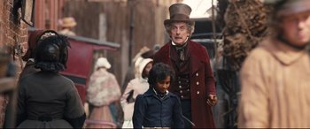 Movie still from “The Personal History of David Copperfield” (2019), directed by Armando Iannucci – A man and a boy dressed up in costumes; Medium shot, Over the shoulder angle