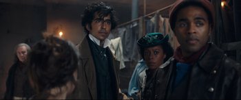 Movie still from “The Personal History of David Copperfield” (2019), directed by Armando Iannucci – A man and a woman standing next to each other; Medium shot, Over the shoulder angle