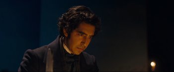 Movie still from “The Personal History of David Copperfield” (2019), directed by Armando Iannucci – A person wearing a suit and tie; Close Up shot, High angle